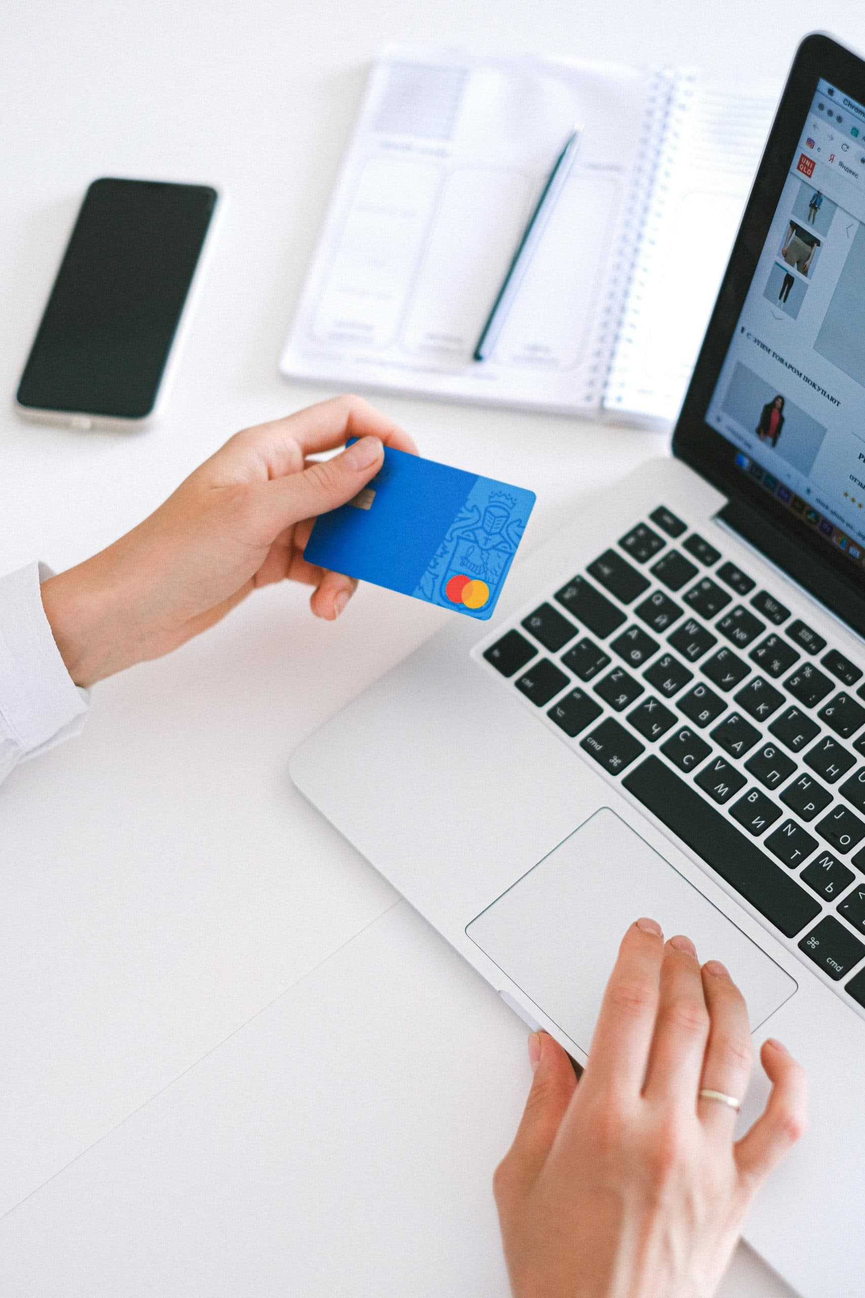 Person sitting at a laptop with a payment card, illustrating how Procode Technology enhances transactions.