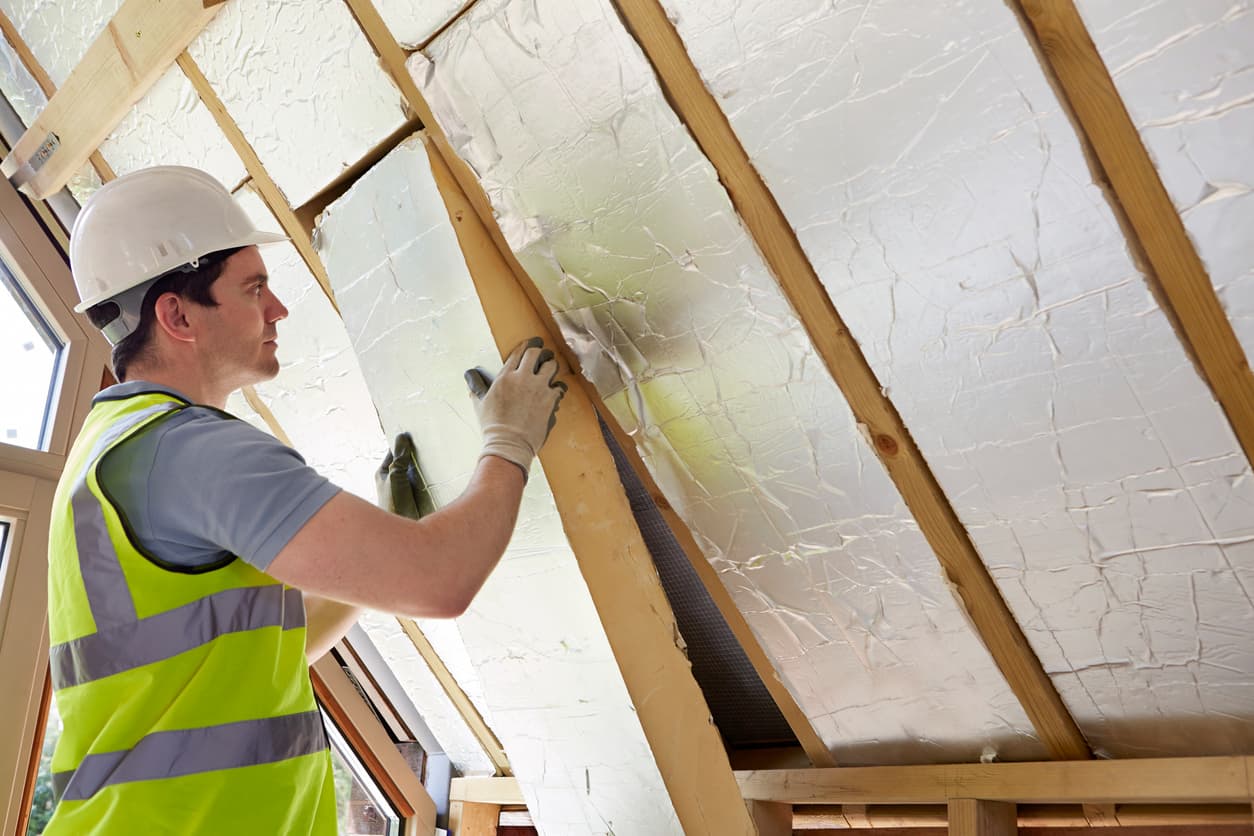Engineer installing energy-saving insulation based on recommendations identified by Procode's Ecofit technology.